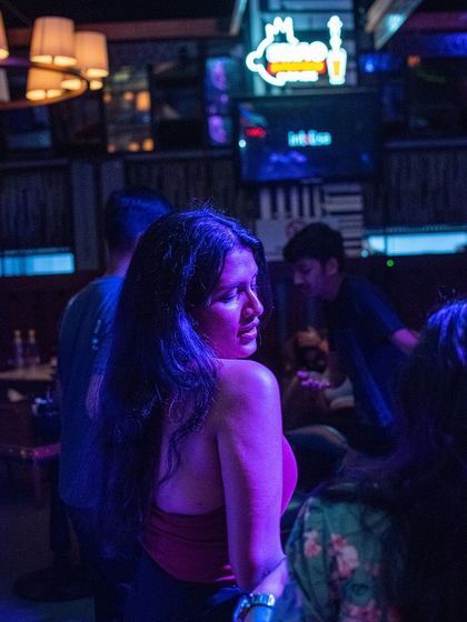 A candid moment on the dance floor at Foxtrot, Marathahalli. The purple lighting creates a cool, intimate mood.