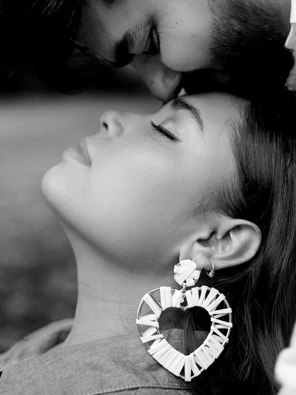 A tender black and white portrait of a couple, capturing a quiet kiss on the forehead. This image emphasizes emotion and connection, making it a timeless memory of your pregnancy journey.