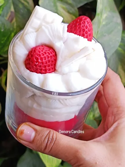 A hand-held shot of the strawberry and cream dessert candle.