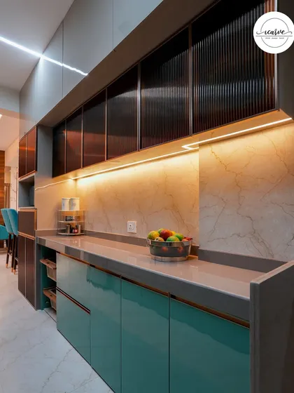The long countertop provides ample space for meal prep, with beautiful lighting enhancing the work area.