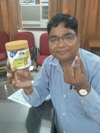 This gentleman is about to try a piece of our amla candy. It is heartening to see people of all ages appreciate the taste of home.