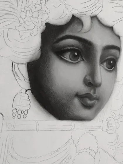 A close-up work-in-progress shot of my charcoal drawing of Krishna. This shows the careful layering and blending process I use to build up realistic skin tones and soft facial features.