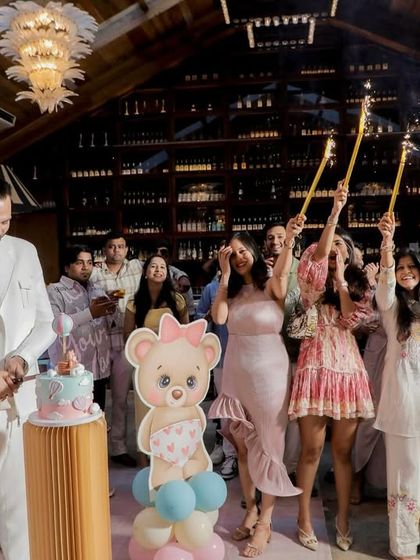 The family gathers for the cake-cutting ceremony, with sparklers adding a festive glow. It’s a beautiful moment of togetherness and celebration.