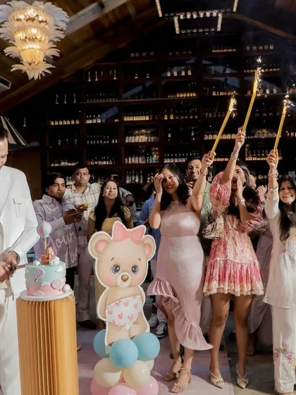 The family gathers for the cake-cutting ceremony, with sparklers adding a festive glow. It’s a beautiful moment of togetherness and celebration.