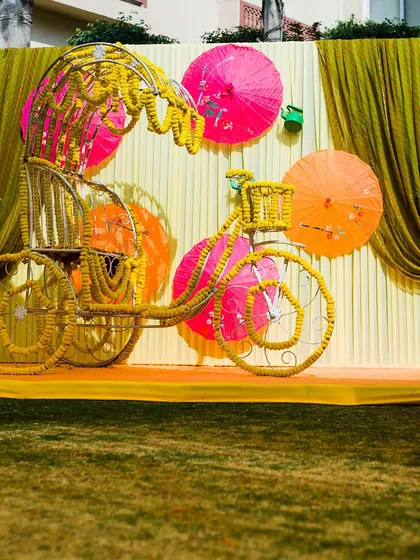 A whimsical photo-op featuring a floral-decorated rickshaw, perfect for a fun and colorful Mehendi or Haldi event.