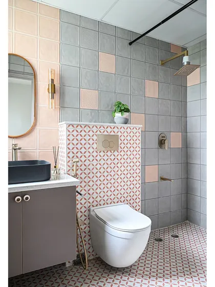 This bathroom renovation shows how color and pattern can completely transform a small space. I used a playful mix of pink and grey tiles, with a bold geometric pattern for the floor and accent wall. Sleek brass fixtures and a modern black sink provide a sophisticated contrast, creating a bathroom that is both fun and stylish.