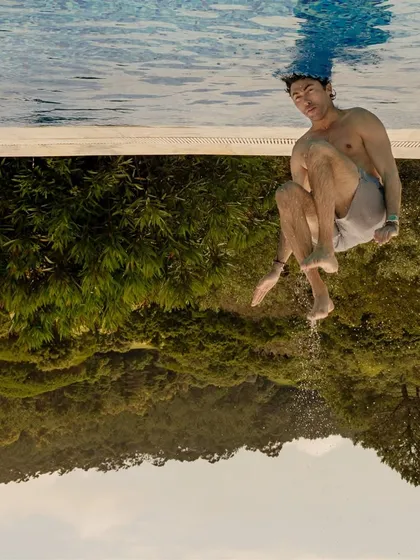 To do justice to the backflipping at this pool party, we flipped the photo. It’s a creative way to capture the wild energy and fun of pre-wedding celebrations.