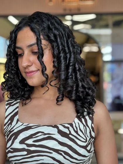 Another angle of this stunning curly hairstyle, highlighting the layers that give the hair movement and volume. This is a perfect example of a wash-and-go style that looks polished.