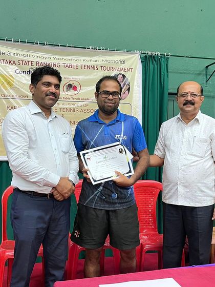 Suramit Samaddar receiving his certificate for a 3rd place finish in the Men's singles at the Belgaum state ranking tournament.