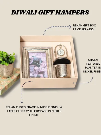 My Diwali gift hampers are curated with love and packed with beautiful, functional decor. This Rehan gift box includes a nickel-finish photo frame, a table clock with a compass, and a textured planter, all ready to gift.