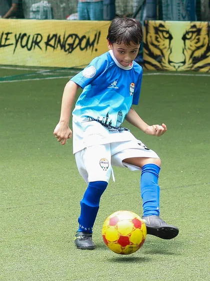 A young player showing off his ball control skills with a series of quick touches.