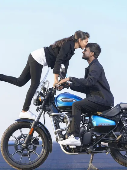 A sweet kiss on the forehead while posing on a motorcycle. This combines a cool prop with a tender, romantic moment.