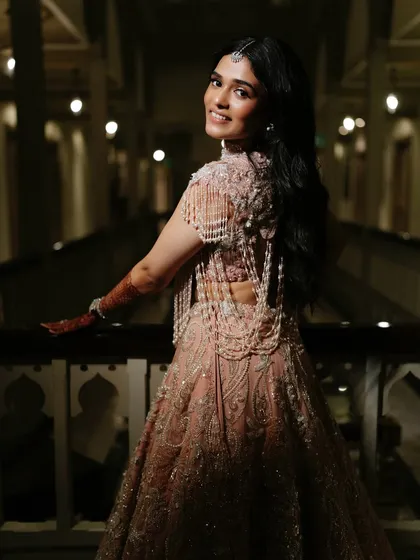 A beautiful back shot showing the full effect of the hair and makeup. The soft waves and glowing skin create a romantic and ethereal vibe, perfect for an engagement celebration.