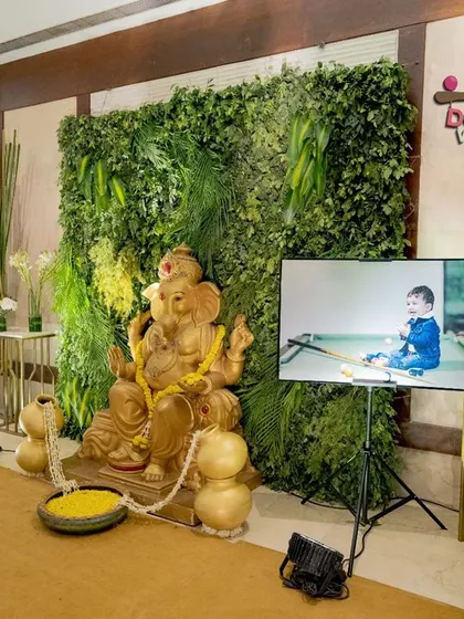 I always find ways to include what's important to your family. For this celebration, we created a special corner that blended a traditional Ganesha idol for blessings with the modern Boss Baby theme, complete with a screen showing pictures of the baby boy.