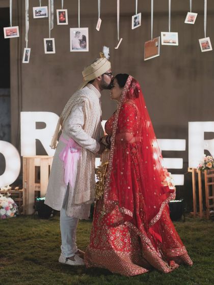 A sweet kiss on the forehead against a backdrop of memories. This romantic wedding portrait tells a story of love and commitment.