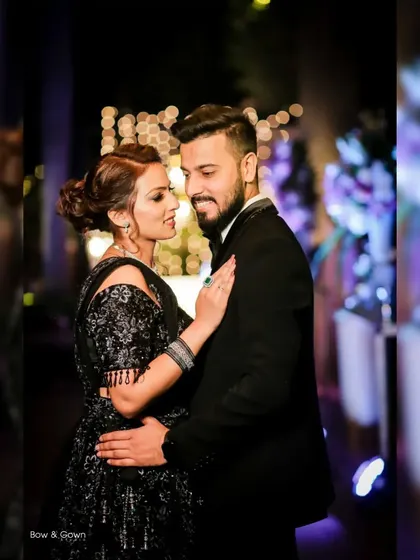 A classic and romantic reception portrait. The groom looks lovingly at his bride, and the soft lighting creates a beautiful, intimate atmosphere.