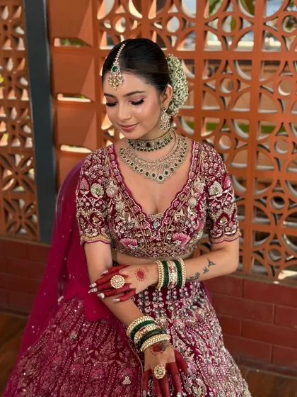 A serene portrait of the bride, her soft makeup complementing the intricate embroidery of her lehenga.