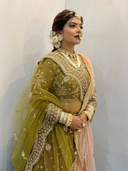 A closer look at the beautiful craftsmanship on this mehndi green bridal lehenga. The delicate floral embroidery on the blouse and the elegant drape of the dupatta showcase the quality of my rental collection.