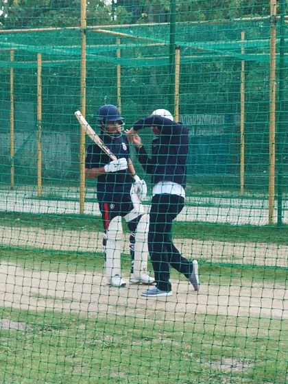 A young batsman receives specific advice on his grip and stance from Virender Sehwag during a net practice. This attention to detail is what sets our cricket coaching apart.
