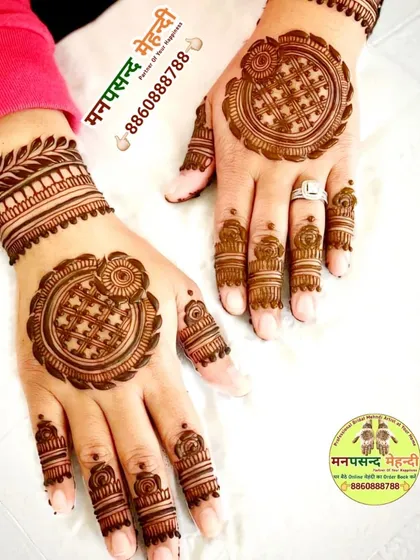 A modern take on the mandala design. The intricate circular pattern on the back of the hand is complemented by detailed work on the fingers.