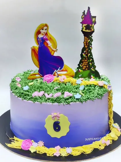 A beautiful Rapunzel cake with her long, flowing hair made from buttercream. This is a zero-fondant design, using edible toppers and frosting to create the magical tower scene.