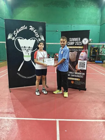 A junior player from our Santacruz East branch receiving her certificate from a coach. Our summer camps are a perfect introduction to professional badminton training.
