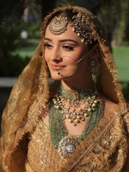 A close-up on the exquisite craftsmanship of the bridal jewelry. The layered necklaces and the intricate nath (nose ring) are central to creating this majestic and timeless bridal look.