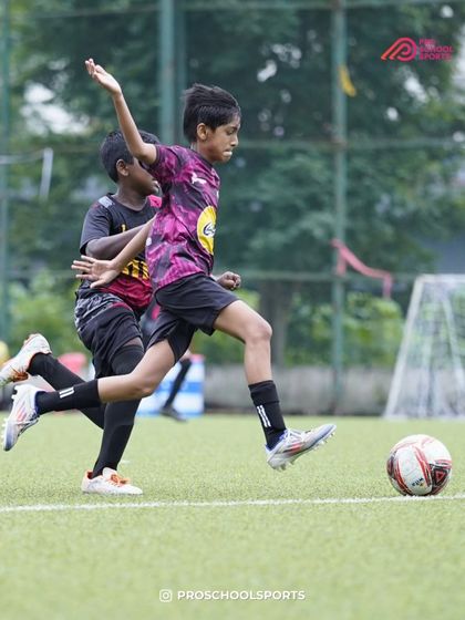 A player about to strike the ball, undeterred by the challenging weather conditions.