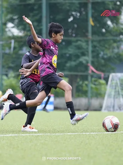 A player about to strike the ball, undeterred by the challenging weather conditions.