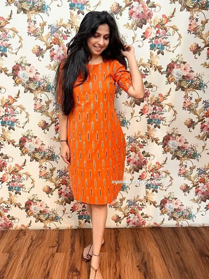 This orange straight-fit Ikat dress is a customer favorite, especially for its simple elegance and practical design. It's a great example of my affordable handloom collection.