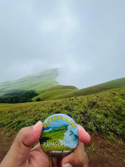 The view from the top of Netravathi Peak, with clouds rolling over the endless green hills. This is the reward that waits for you after a challenging and beautiful monsoon trek.