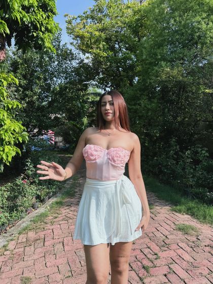 A playful pose in the summery floral corset and skort.