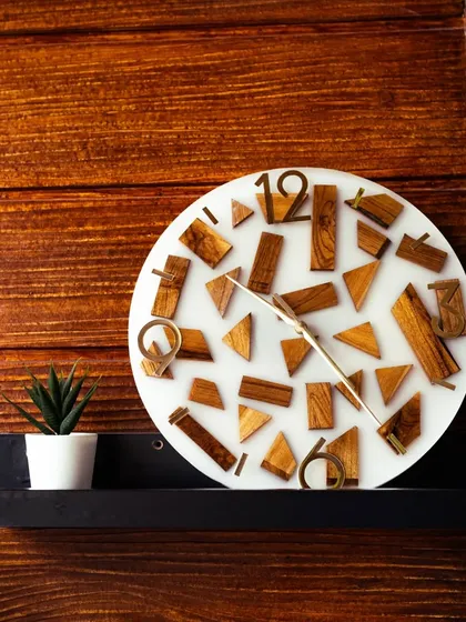 The combination of wood and resin creates magic every time. For this clock, I used individual teak wood blocks arranged in a modern, abstract pattern and set them in a milky white resin base. The golden acrylic numbers and silent sweep machine complete this functional piece of art.