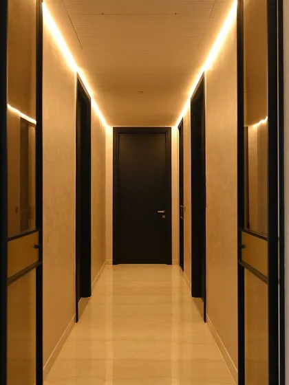Cove lighting in this hallway provides a soft, indirect glow that makes the space feel wider and more inviting. It's an elegant solution for transitional areas.