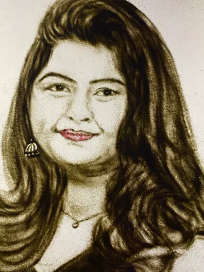 A finished sand portrait, commissioned by a client as a special gift. The subtle use of color for the lips and the detail in the hair and jewelry make the portrait come alive.
