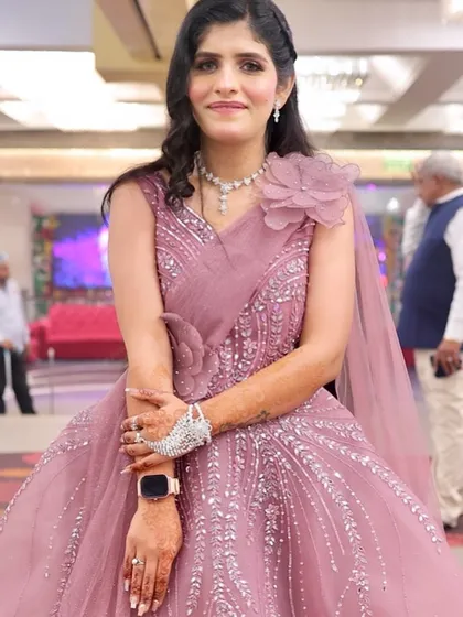 Another angle of the pink floral gown look. The soft curls and radiant makeup create a beautiful and feminine style.