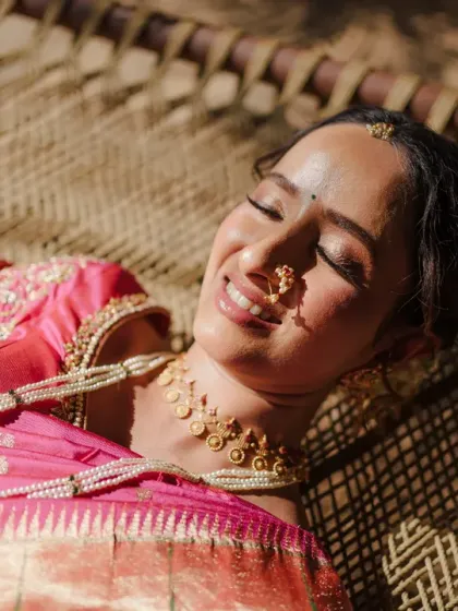 A moment of serene beauty for a Maharashtrian bride, basking in the sun before her ceremony. We love capturing the unique cultural details and the quiet, personal moments that make each wedding story special, like the traditional nath and the peaceful glow of a bride.
