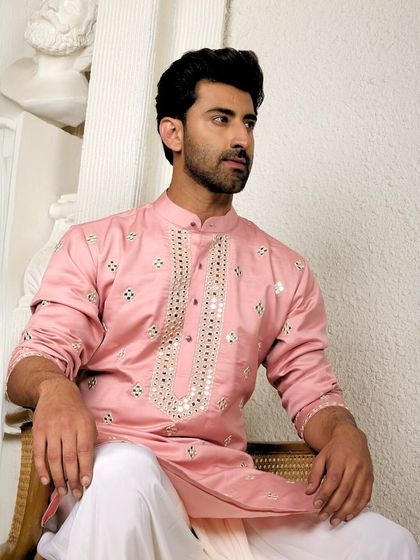 This striking pink ethnic kurta with mirror work is designed for you to own the moment. It's a standout piece that reflects confidence and individuality.
