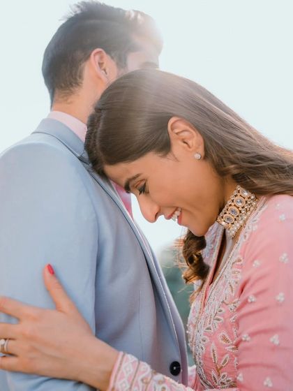 A soft and romantic pre-wedding look in a beautiful pink outfit. The makeup is dewy and glowing, with a focus on rosy cheeks and a natural lip.