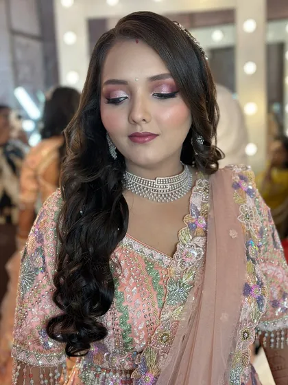 An Indo-western glam look, perfect for a reception, featuring bold pink eyeshadow and a chic hairstyle.