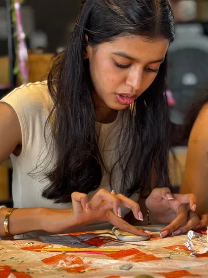 A participant deeply focused on her craft. We are uniting creators, dreamers, and doers in real life.
