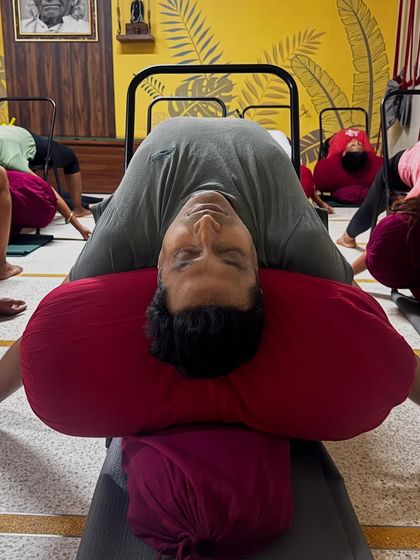 Part of a de-stress sequence: Supta Virasana (Reclining Hero Pose) over bolsters. This pose opens the chest and abdomen, promoting deep, restful breathing.