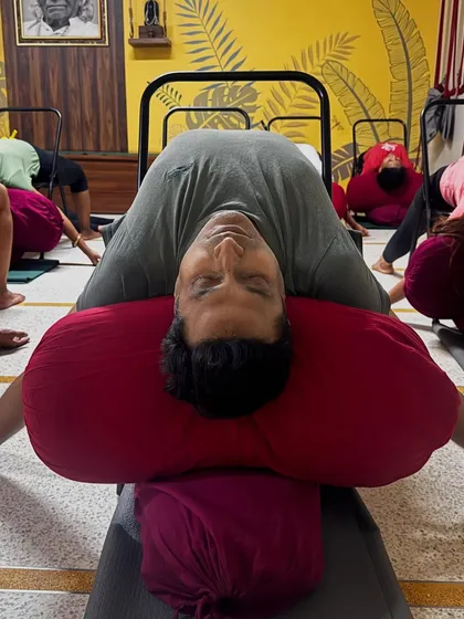 Part of a de-stress sequence: Supta Virasana (Reclining Hero Pose) over bolsters. This pose opens the chest and abdomen, promoting deep, restful breathing.