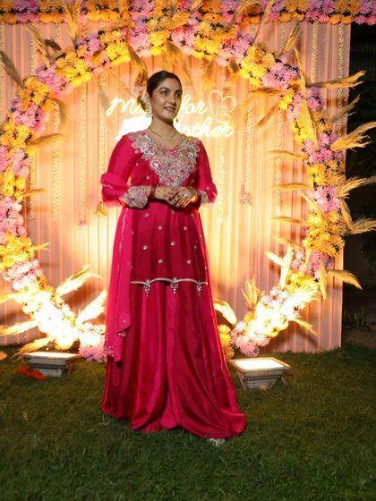 Posing against a festive backdrop. This outfit is perfect for a sangeet, mehendi, or even a daytime wedding.