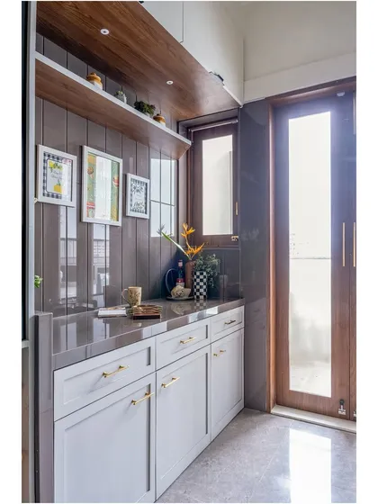 Another view of the utility counter, highlighting the warm wood shelving and elegant gold-toned hardware that elevates the design.