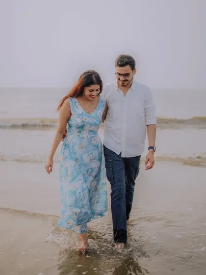 Walking along the shore, lost in their own world. This photo of Jayashree and Anand captures a natural, candid moment from their romantic beach pre-wedding shoot.