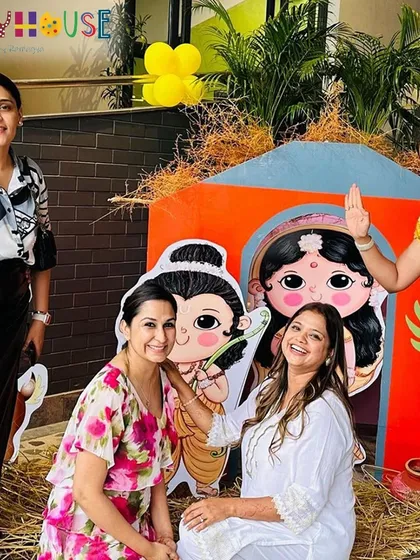 Guests having fun and posing with the cute Ram and Sita cutouts at the Ramayan-themed party.