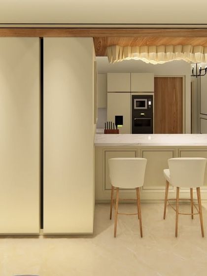 This elegant bar area features a white marble countertop and classic wall paneling. The custom cabinetry is designed to be concealed, maintaining a clean and minimalist look when not in use.