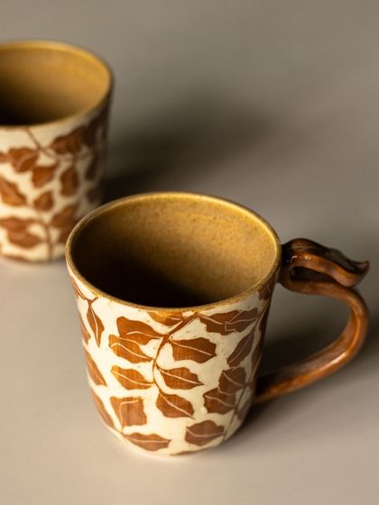 A stunning sgraffito mug with a leaf pattern. The artist gets into a total trance while carving these, and the results are just breathtaking.