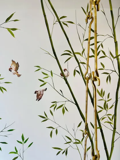 A close-up of the sparrows in the bamboo mural. Each bird is painted with care to capture its lively character as it flits between the branches.